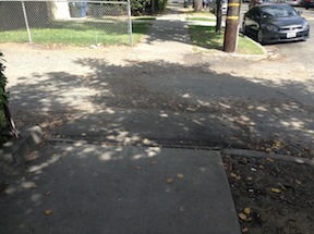 rough alleyway crossing of sidewalk, 24th St