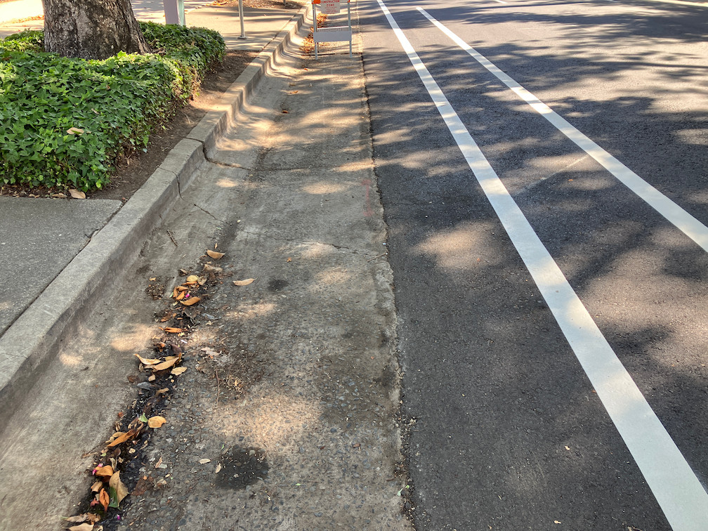 19th St separated bikeway in the gutter pan